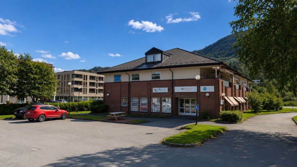 Moderne klinikkbygning i naturskjønne omgivelser med parkering.