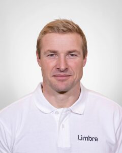 Kiropraktor fra Limbra smilende foran hvit bakgrunn.