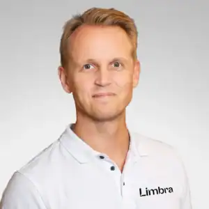 Portrett av Magnus Prener Holtan i hvit skjorte med Limbra-logo.