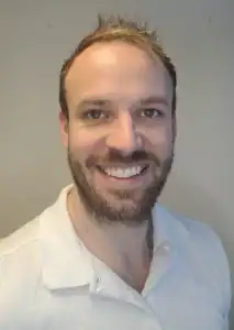 Fredrik Tvedten smilende mann med lyst hår og skjegg.