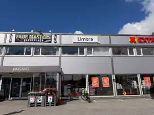Utsikt over Limbras butikkfront med barberbutikk og Extra supermarked.
